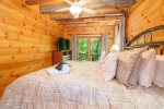 Main Level Bedroom Features King Size Bed, Flat Screen TV, & Access To Covered Deck